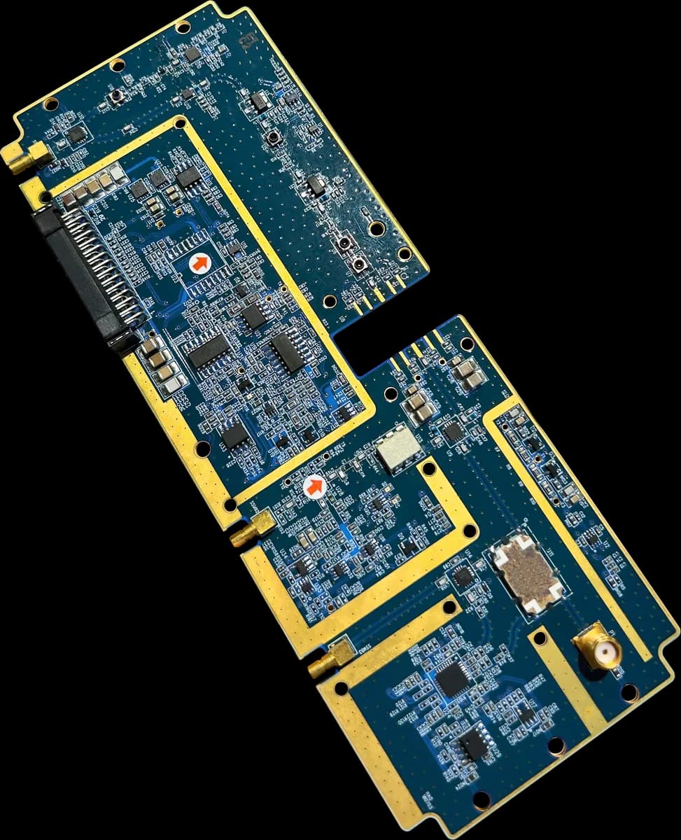 A blue RF transceiver board with gold-plated edges and shielded sections