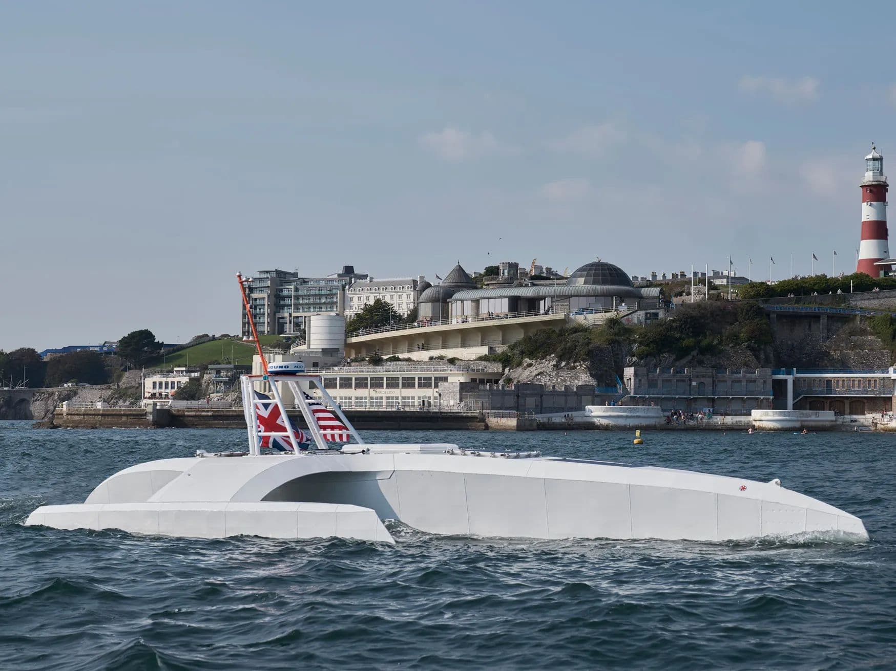 An uncrewed surface vessel moving along a coastline