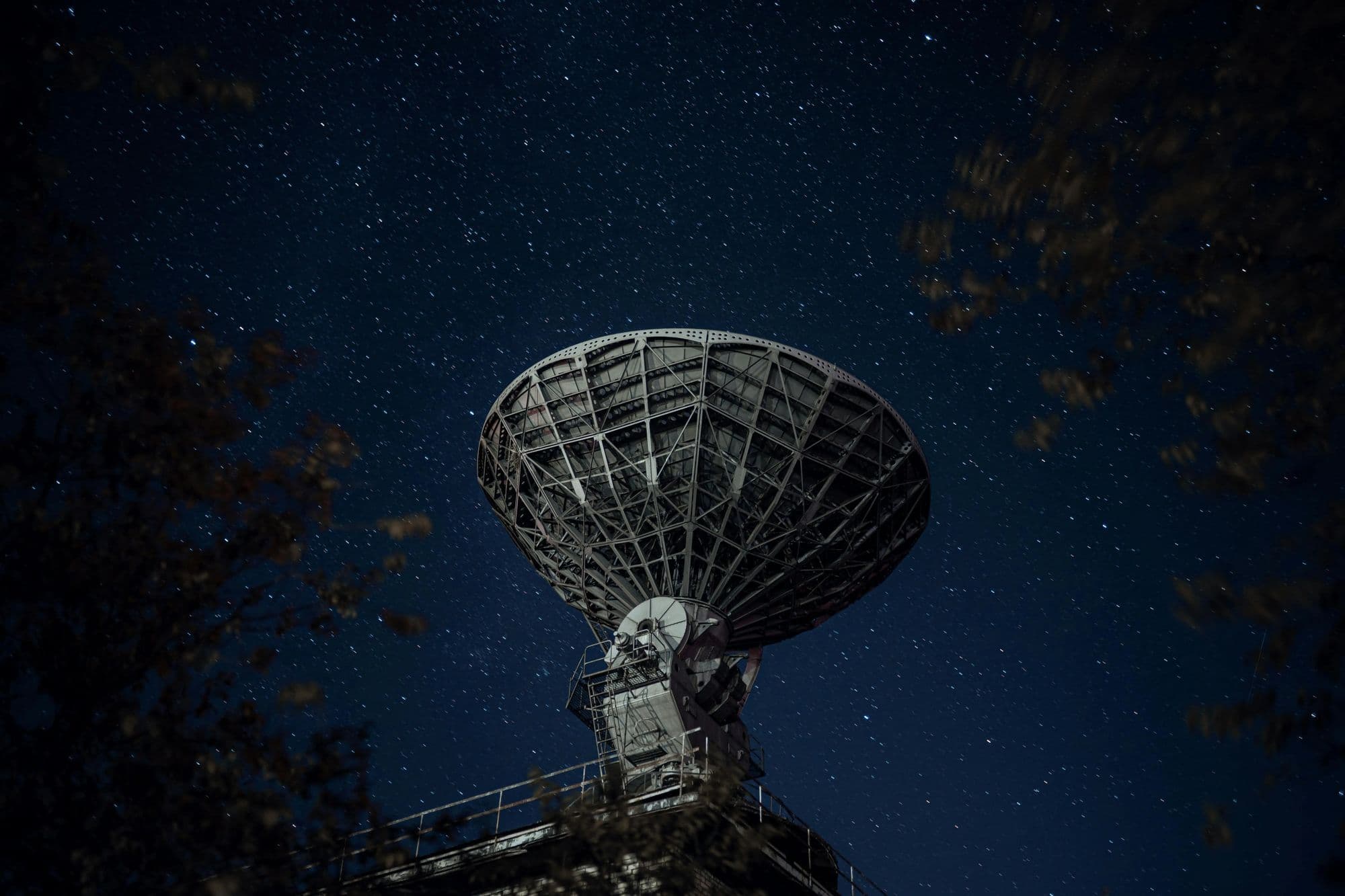 A radar dish against a night sky